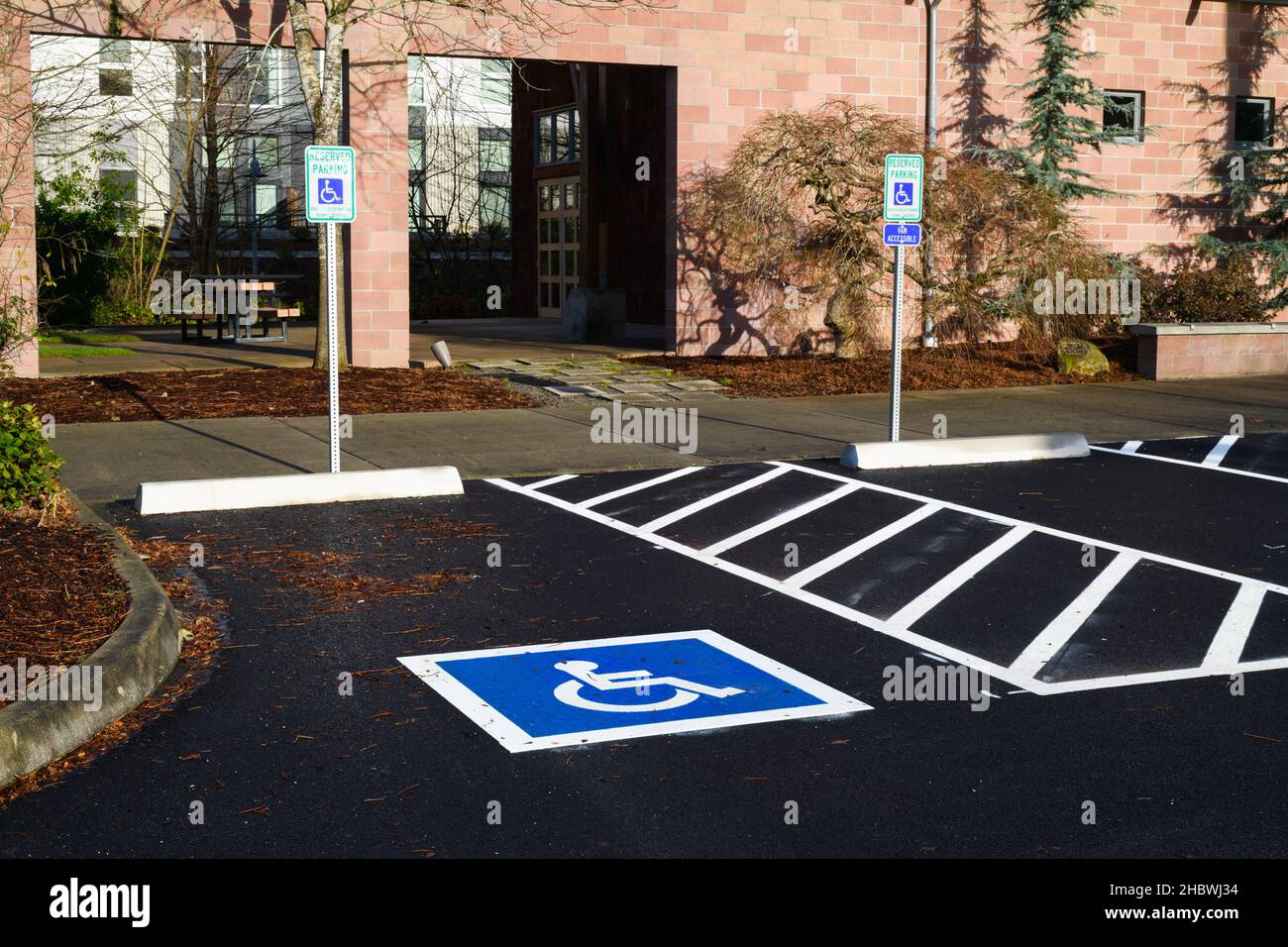 Woodinville, WA, USA - December 19, 2021; State disability parking spaces with road markings and signage in the urban area of Woodinville Washington Stock Photo