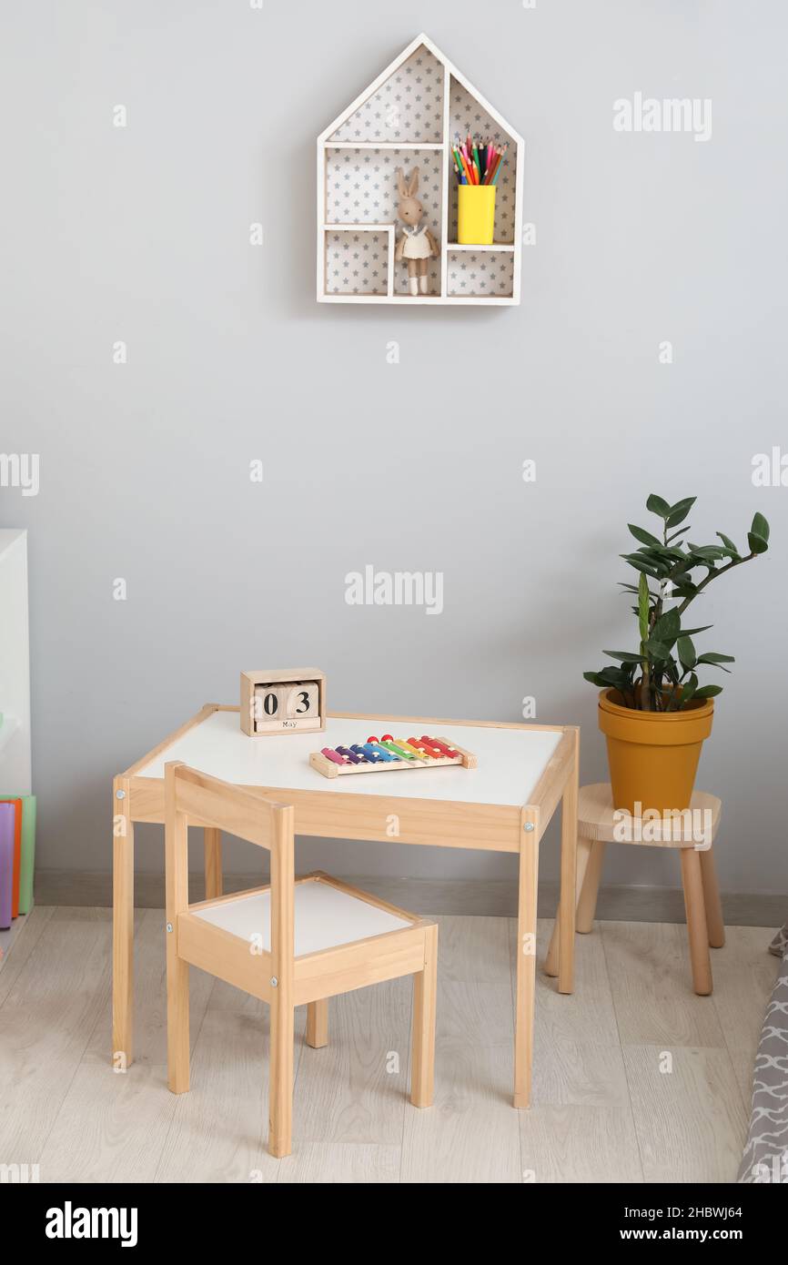 Stylish interior of modern children's room with table and chair Stock ...