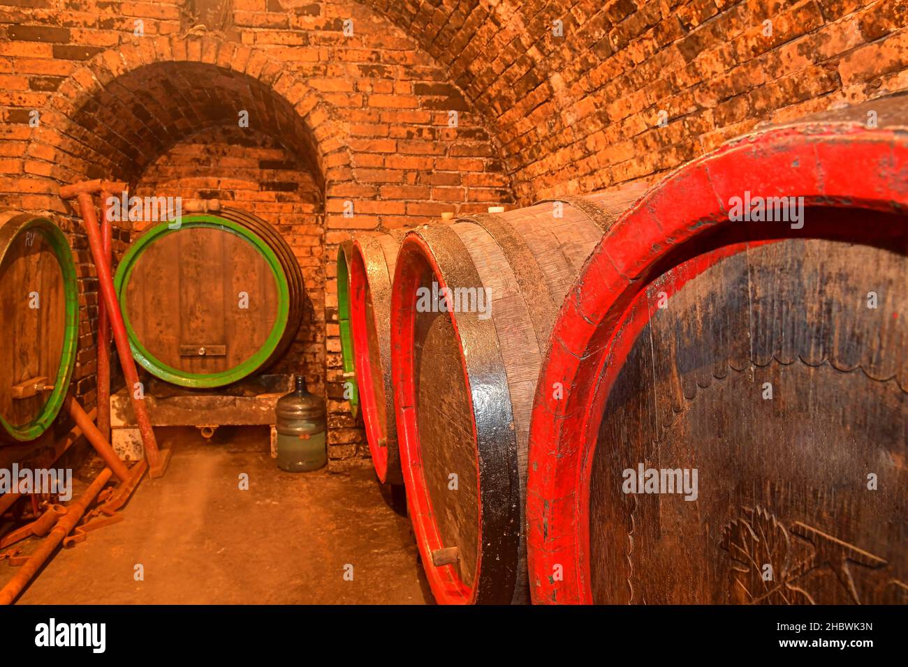 Barrels of wine in a wine cellar, an ancient wine cellar with vaulted