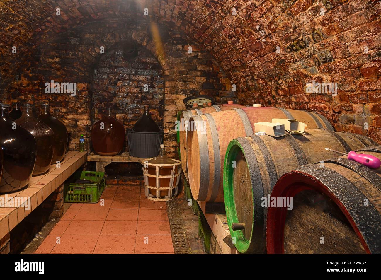 Vintage demijohns in a traditional wine cellar. Demijohn wine bottles
