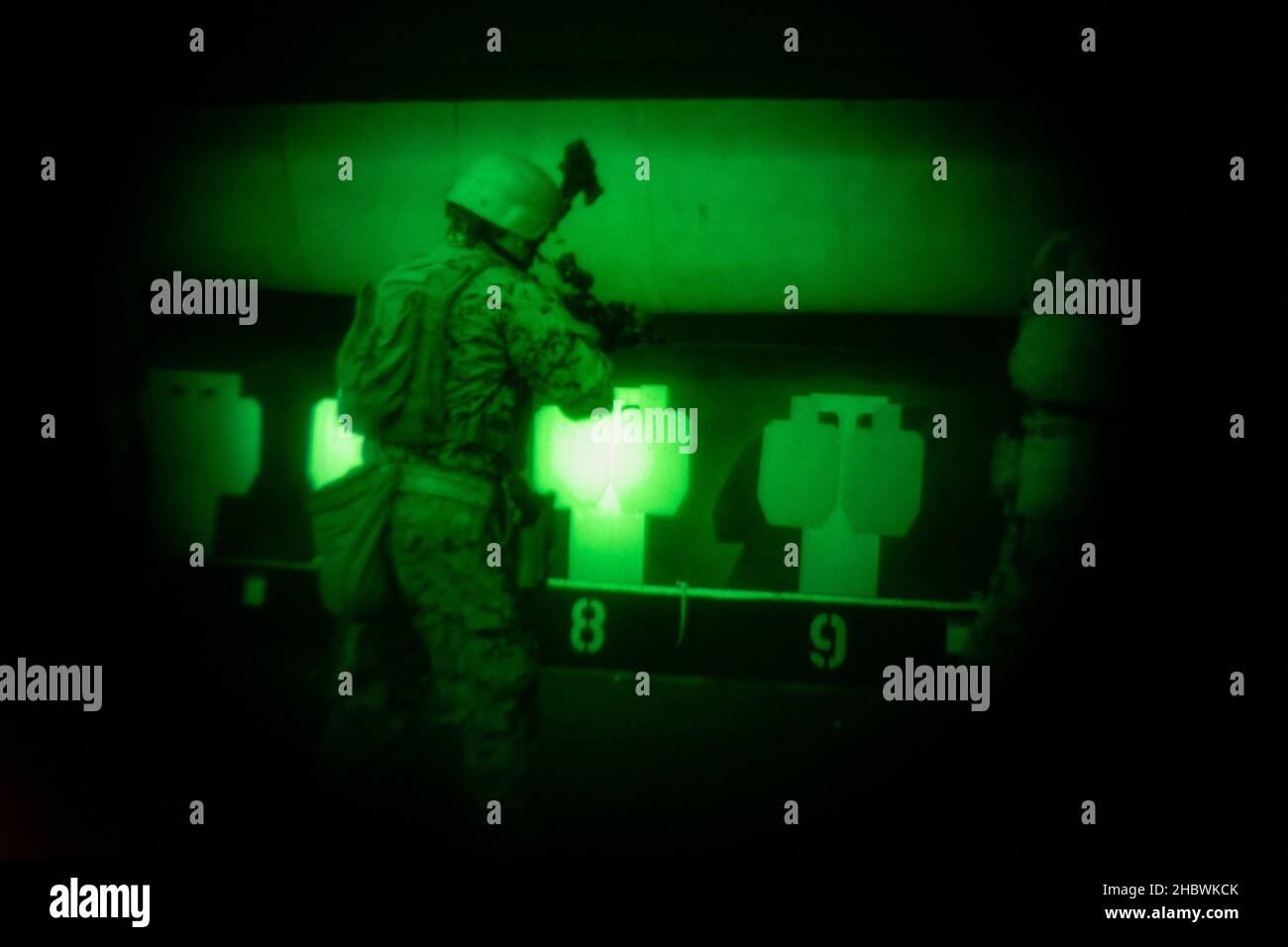 U.S. Marine Corps Sgt. Hector A. Espinoza, a rifleman and security force training course instructor with Marine Corps Security Force Regiment Training Company, fires a C8 carbine rifle while conducting low-light engagement drills during exercise Tartan Eagle Phase II, Northumbria Police Range, Wallsend, England, Dec. 12, 2021. The range allowed British Royal Marine close-quarters battle (CQB) instructors to introduce various shooting techniques to the U.S. Marines and test their proficiency in enemy engagement with limited lighting. Exercise Tartan Eagle is a bilateral biyearly training exerci Stock Photo