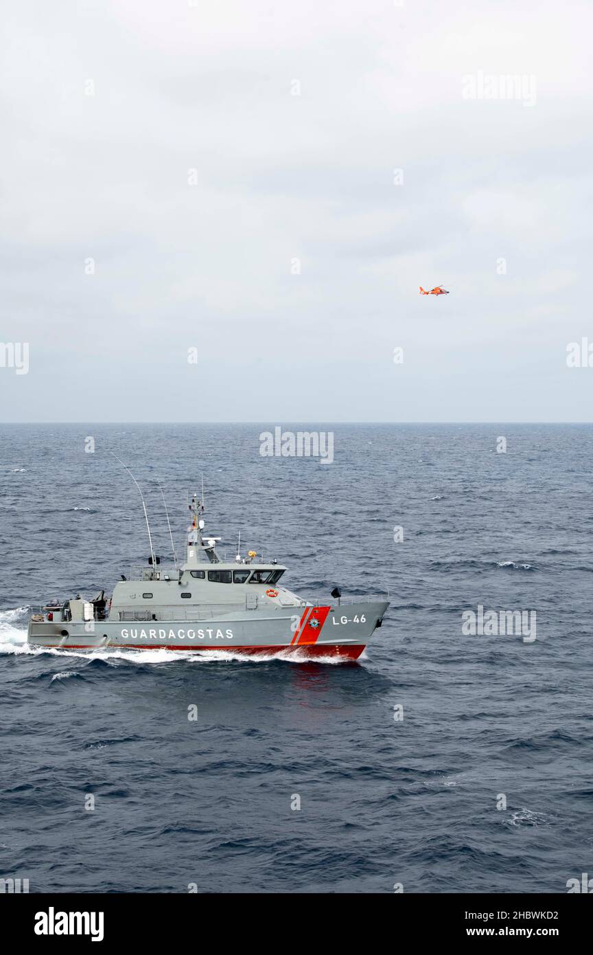 The crews of U.S. Coast Guard Legend-class national security cutter USCGC Stone (WMSL 758), an attached MH-65 helicopter aircrew, and the Ecuadorian naval patrol vessel Isla Pinta (LG-46) conduct exercises and question a vessel crew in the Eastern Pacific Ocean, Dec. 7, 2021. U.S. and Ecuadorian law enforcement and security personnel work cooperatively to counter threats posed by transnational crime, illicit narcotics, and human trafficking. (U.S. Coast Guard photo by Petty Officer 2nd Class Shannon Kearney) Stock Photo