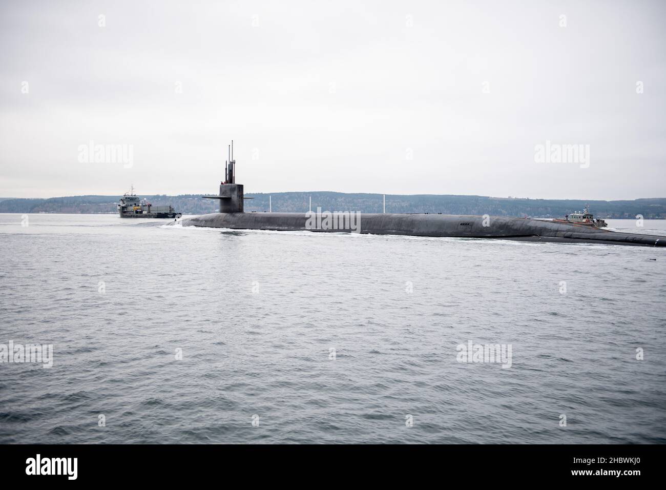 The Ohio-class ballistic missile submarine USS Kentucky (SSBN 737) transits the Hood Canal as the boat returns to its homeport of Naval Base Kitsap-Bangor, Washington from a scheduled patrol Dec. 21, 2021. Kentucky is one of eight ballistic missile submarines stationed at the base, providing the most survivable leg of the strategic deterrence triad for the U.S. (U.S. Navy Photo by Mass Communication Specialist 2nd Class Emilia Hilliard) Stock Photo