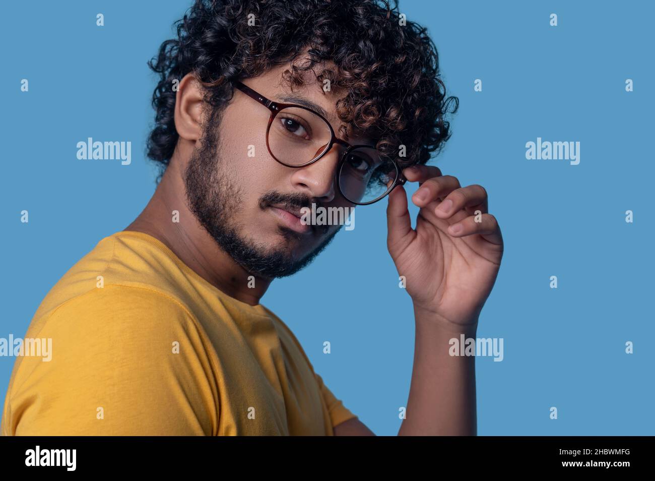Serious man in round eyeglasses looking ahead Stock Photo