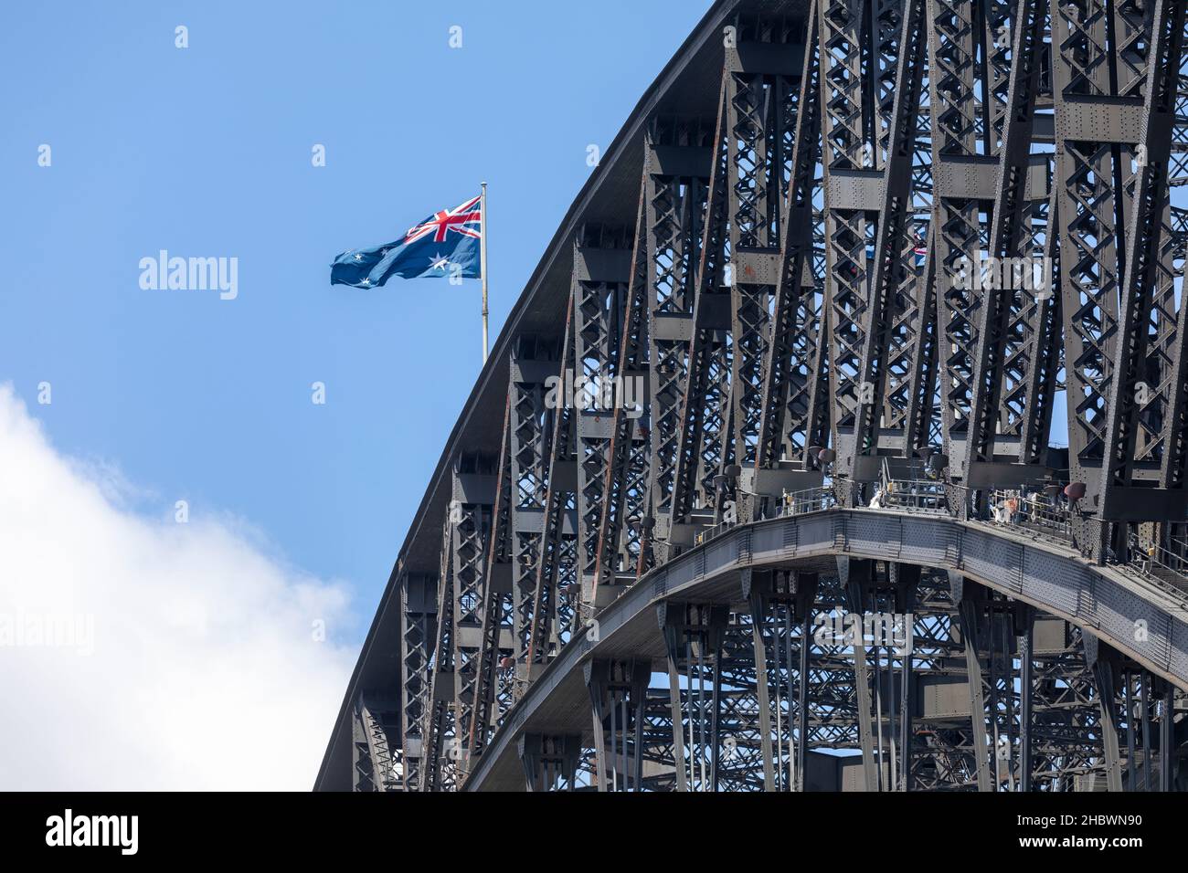 close up Sydney harbour bridge structure and australian national flag