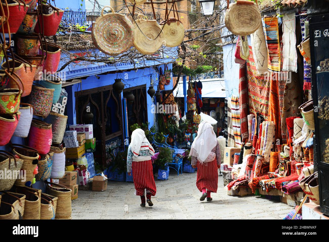 traditionally dressed Moroccan women walking in the old medina of Chefchaouen, Morocco. Stock Photo