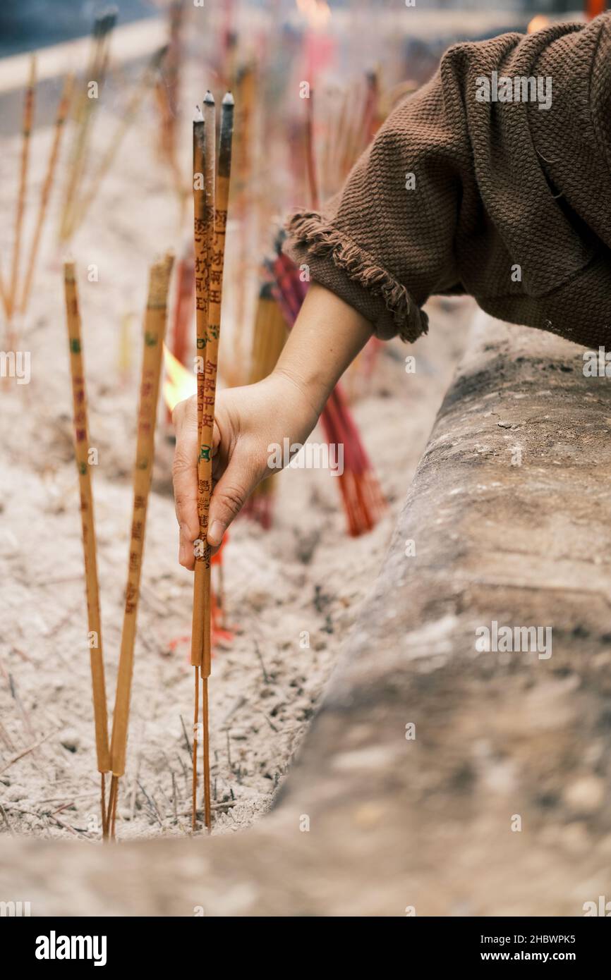 hand an incense, translate the text in the picture family peace Stock