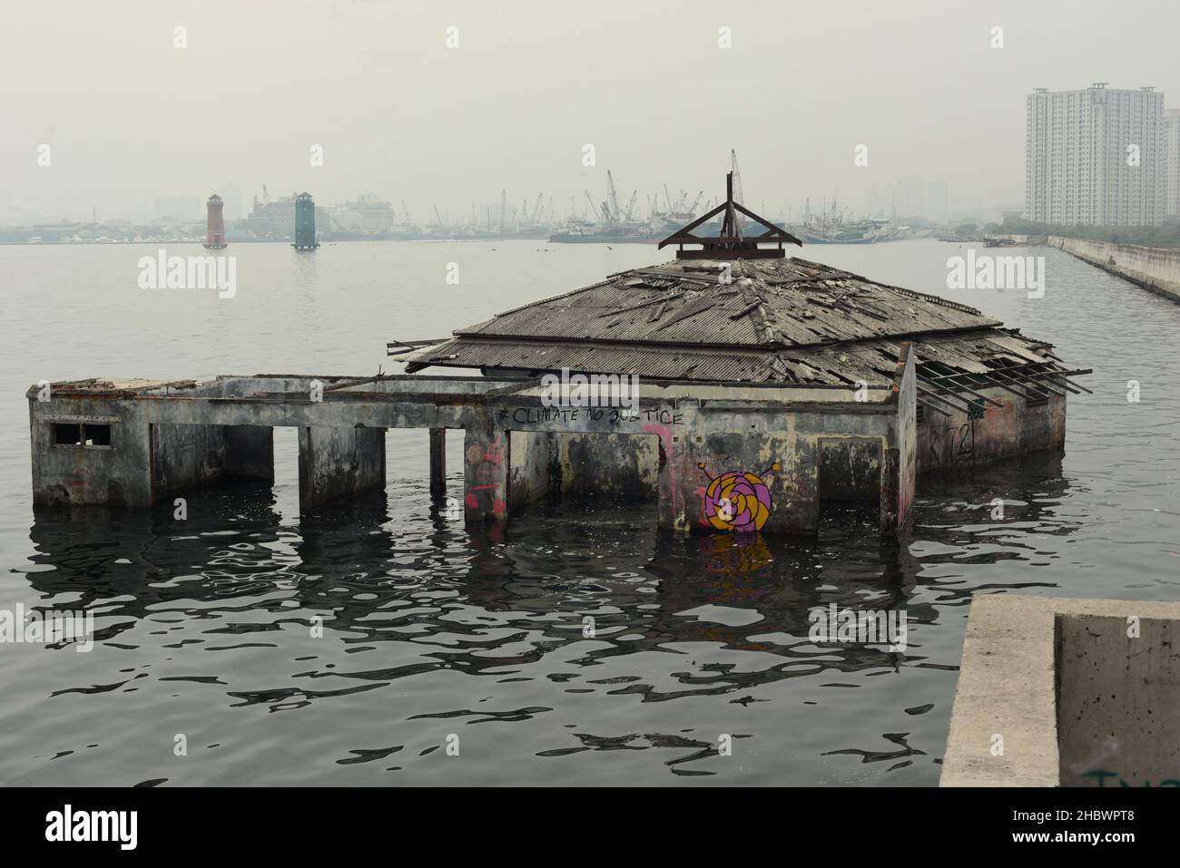 A mosque building that has been abandoned for decades due to sea level rise, coastal abrasion and land subsidence on the coastal area of Jakarta, Indonesia. Stock Photo