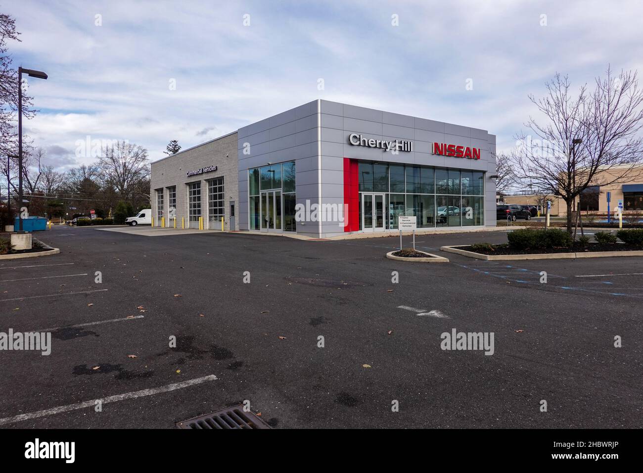 Cherry Hill, New Jersey - December, 2021: A Nissan car dealership with its parking lot almost empty due to a supply chain disruptions of materials use Stock Photo