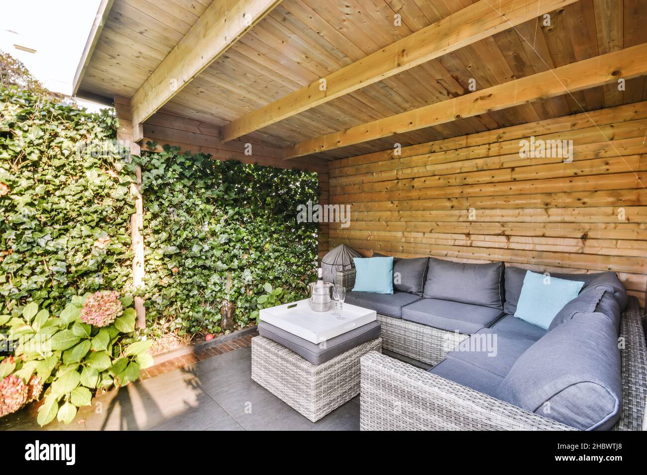 Lovely courtyard with wicker sofas and upholstered seats Stock Photo