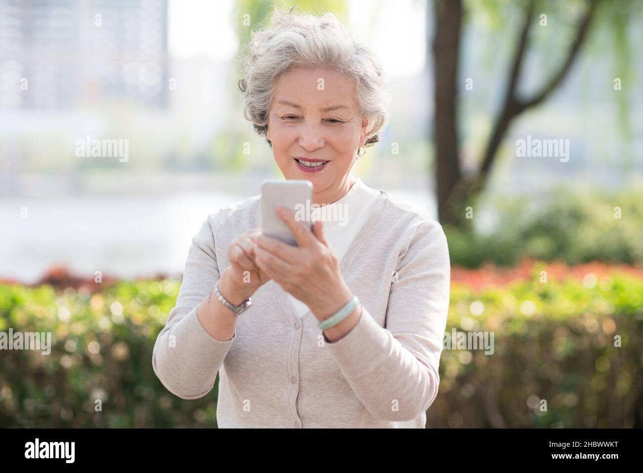 Older woman using smartphone Stock Photo