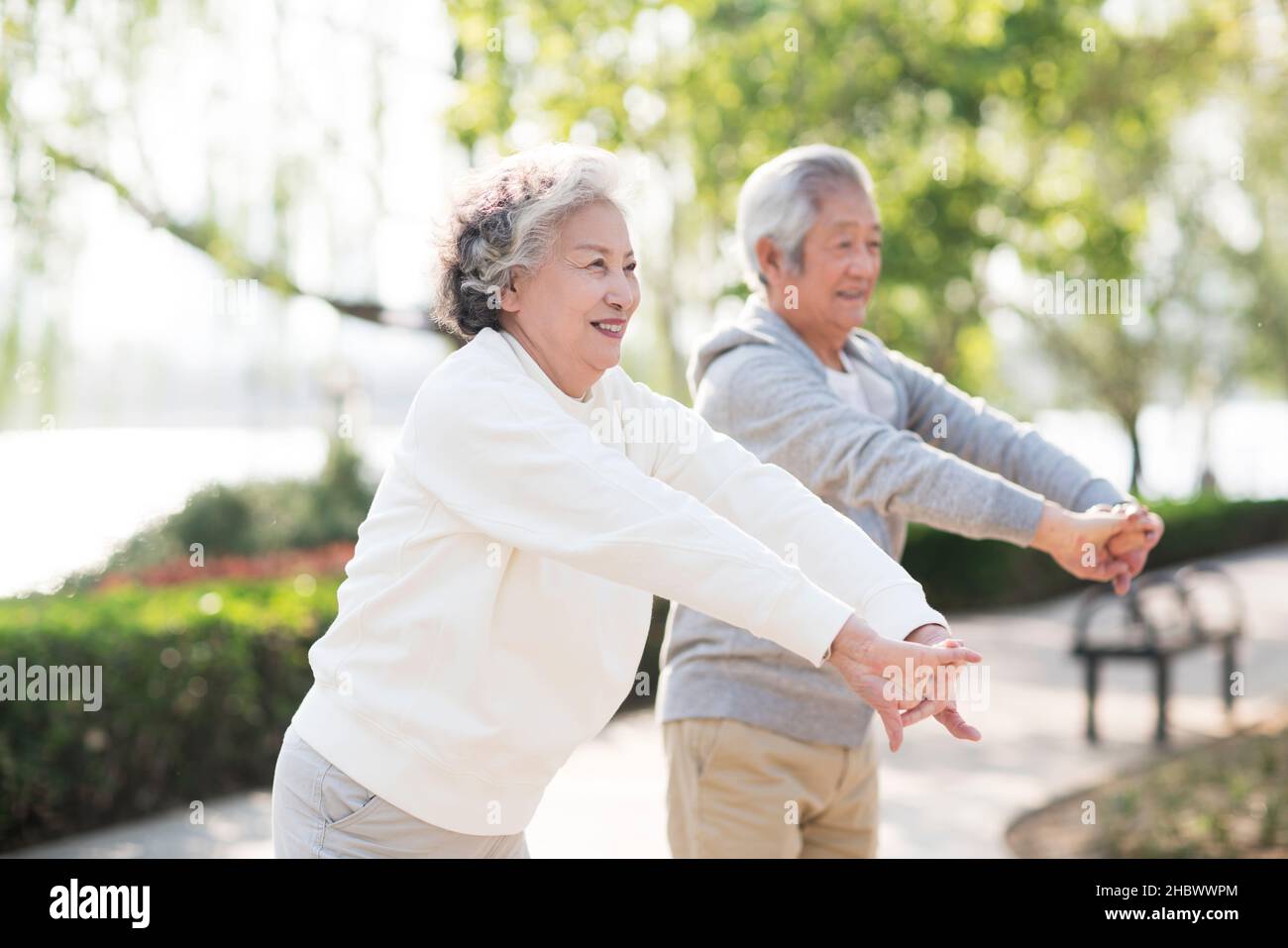 Elderly couple exercising in the park Stock Photo