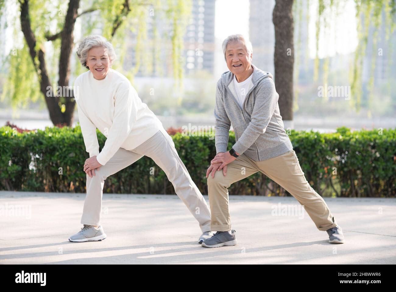 Elderly couple exercising in the park Stock Photo - Alamy