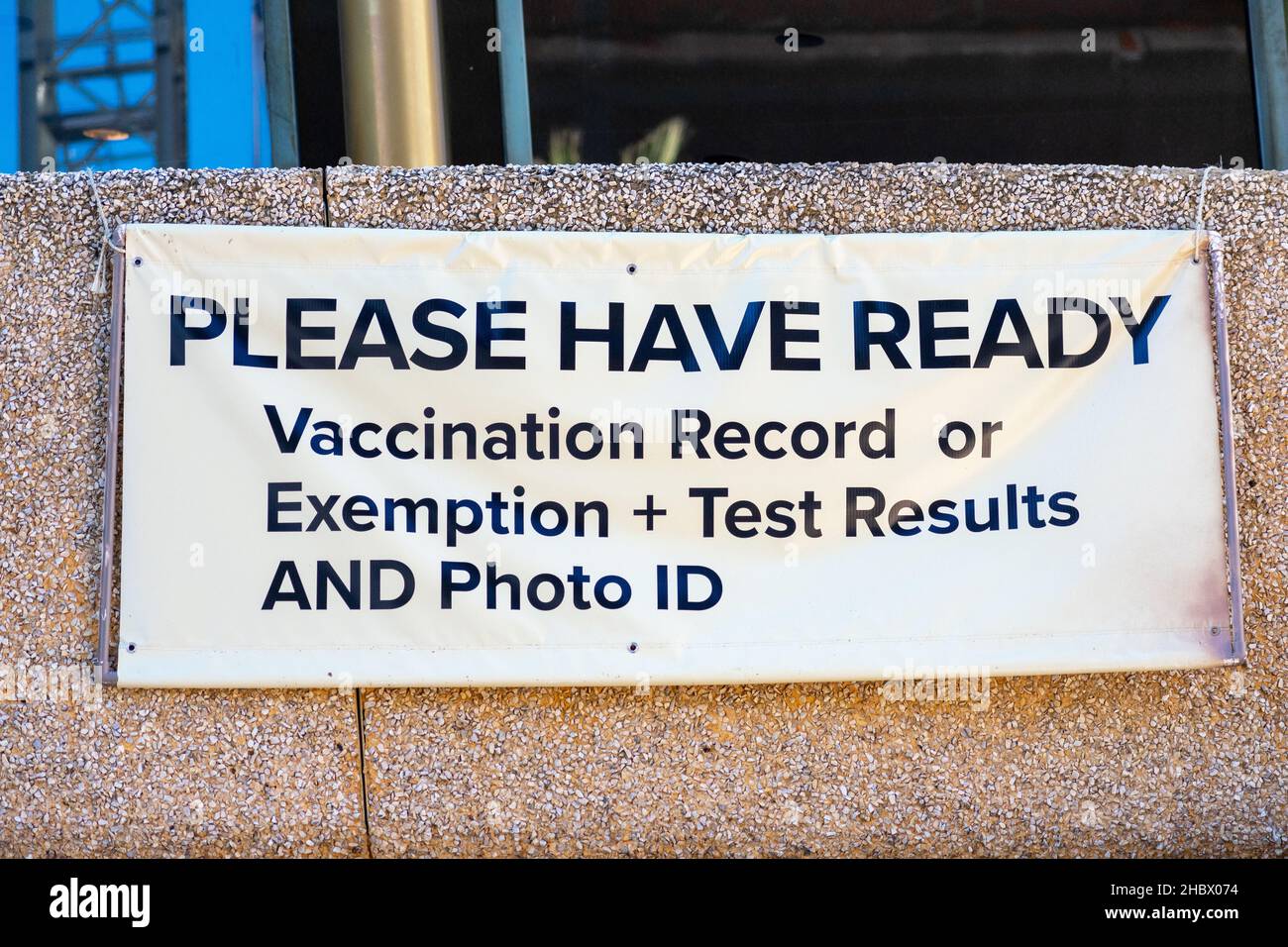 Covid-19 vaccination record or exemption and test results sign at the entrance to concert or stadium as a requirements to attend indoor public event Stock Photo