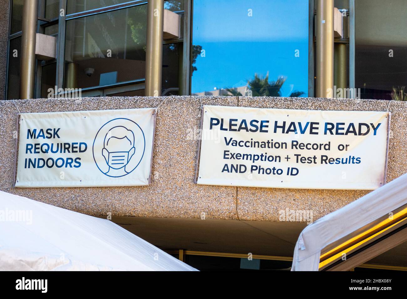 Face masks, Covid-19 vaccination record or exemption and test results sign at the entrance to concert or stadium as a requirements to attend indoor pu Stock Photo