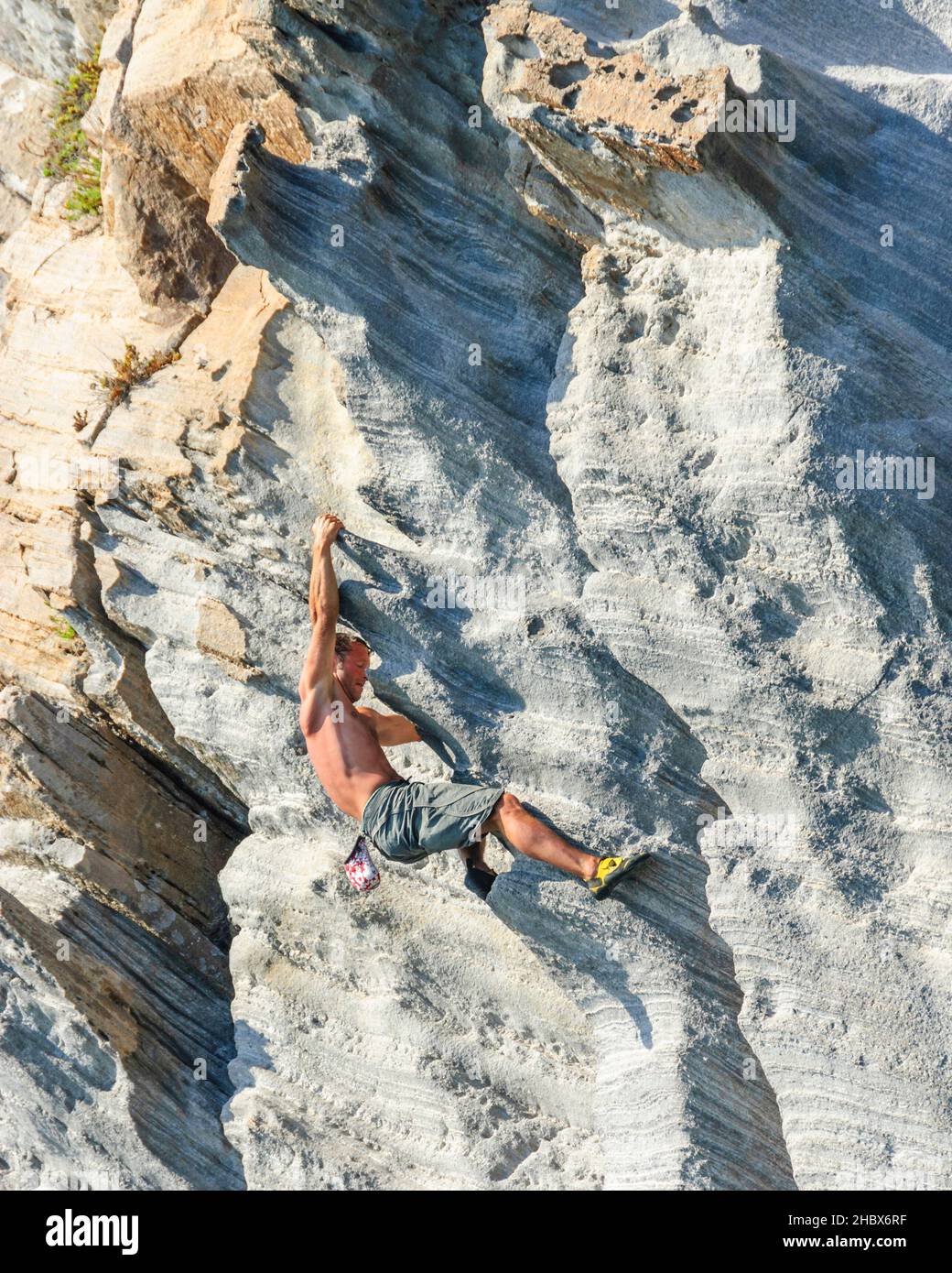 Man climbing at the cliffs of Bassiluzzo Stock Photo