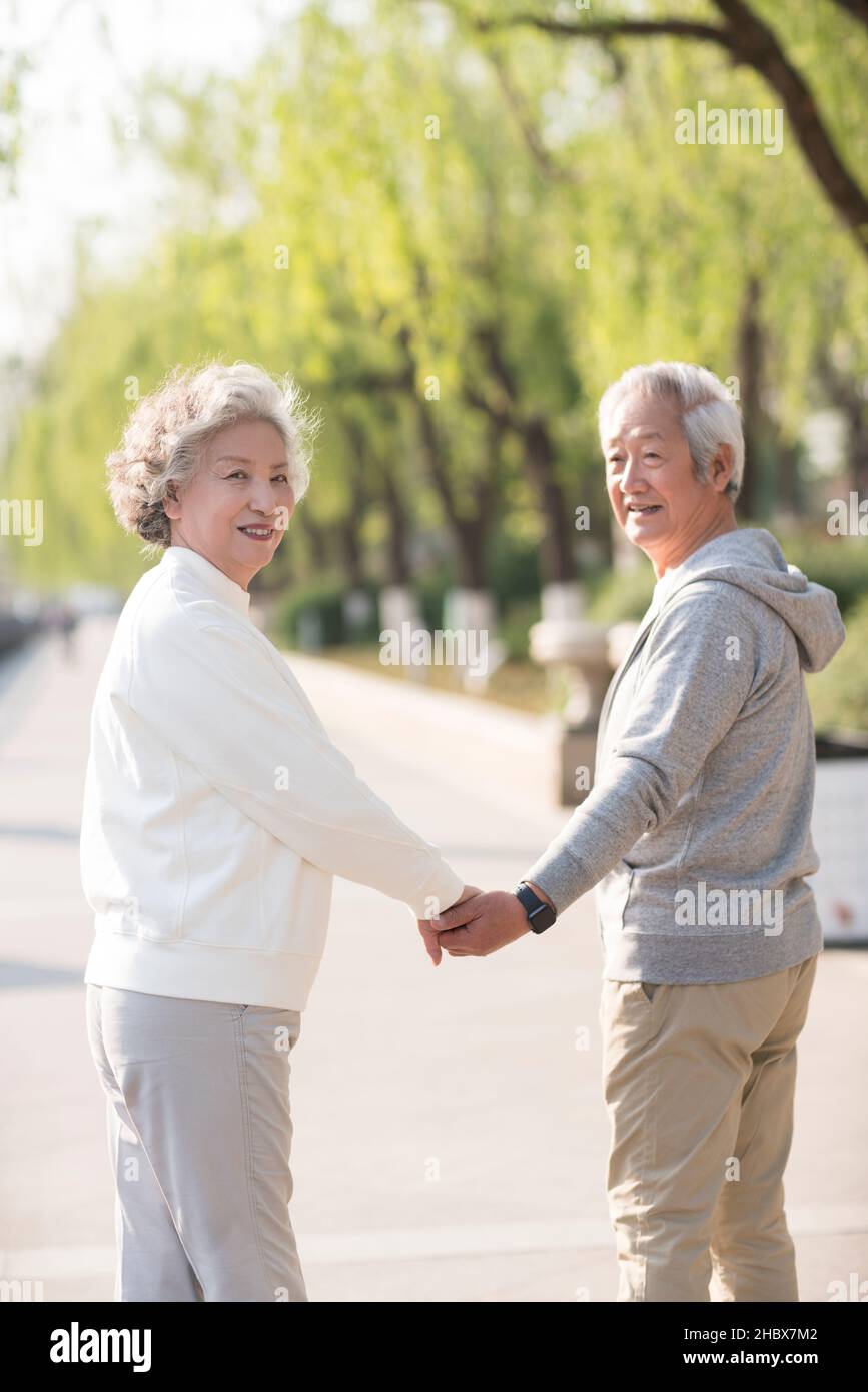 Old couple walking in the park Stock Photo