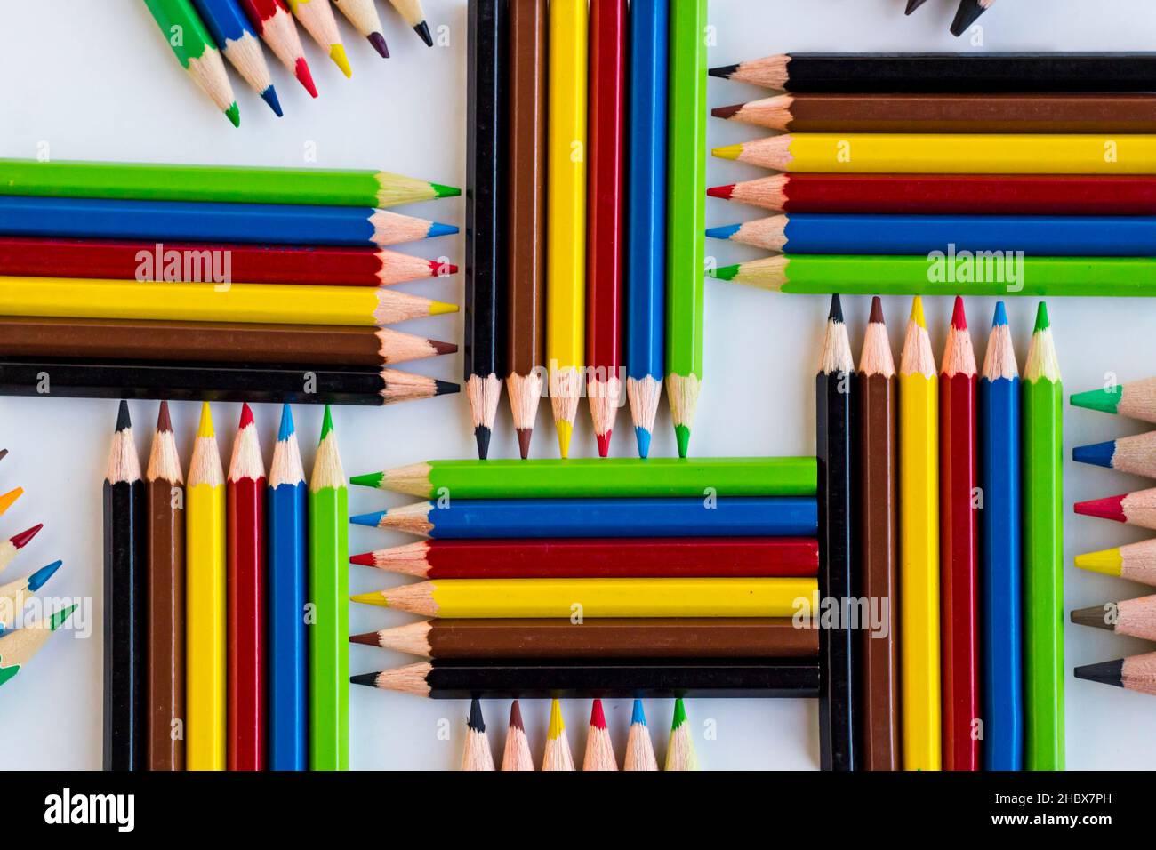Colorful crayons,pencils designed group of five on the white surface,top view. Stock Photo