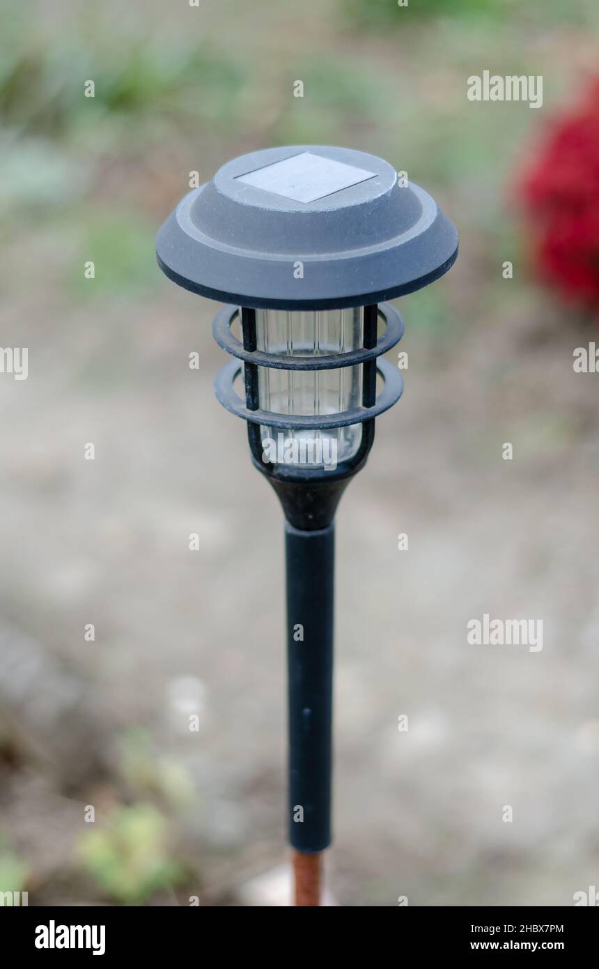 Decorative small solar garden light. Garden design. Solar-powered lantern. Selective focuse Stock Photo