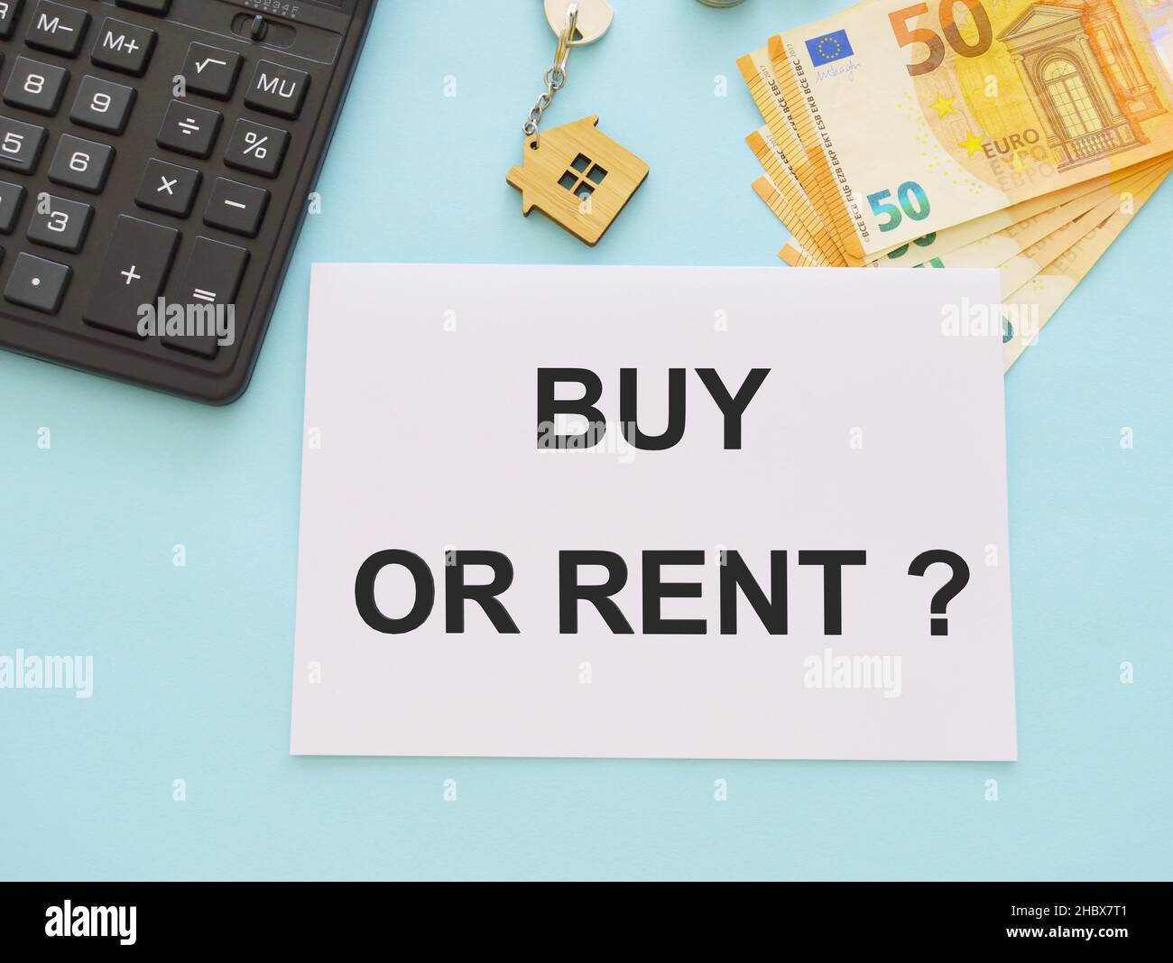 buy or rent concept, text on white paper, real estate, light blue