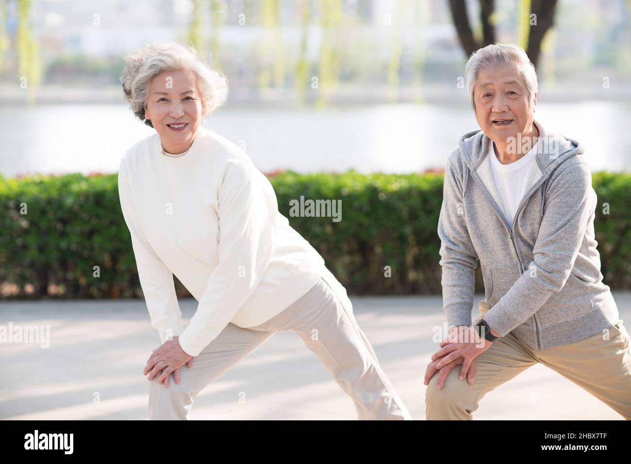 Elderly couple exercising in the park Stock Photo