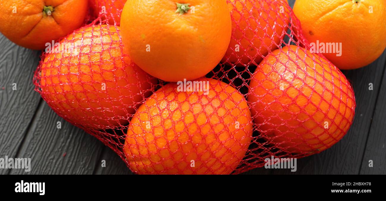 Net bag with many fresh ripe tangerines, closeup Stock Photo - Alamy