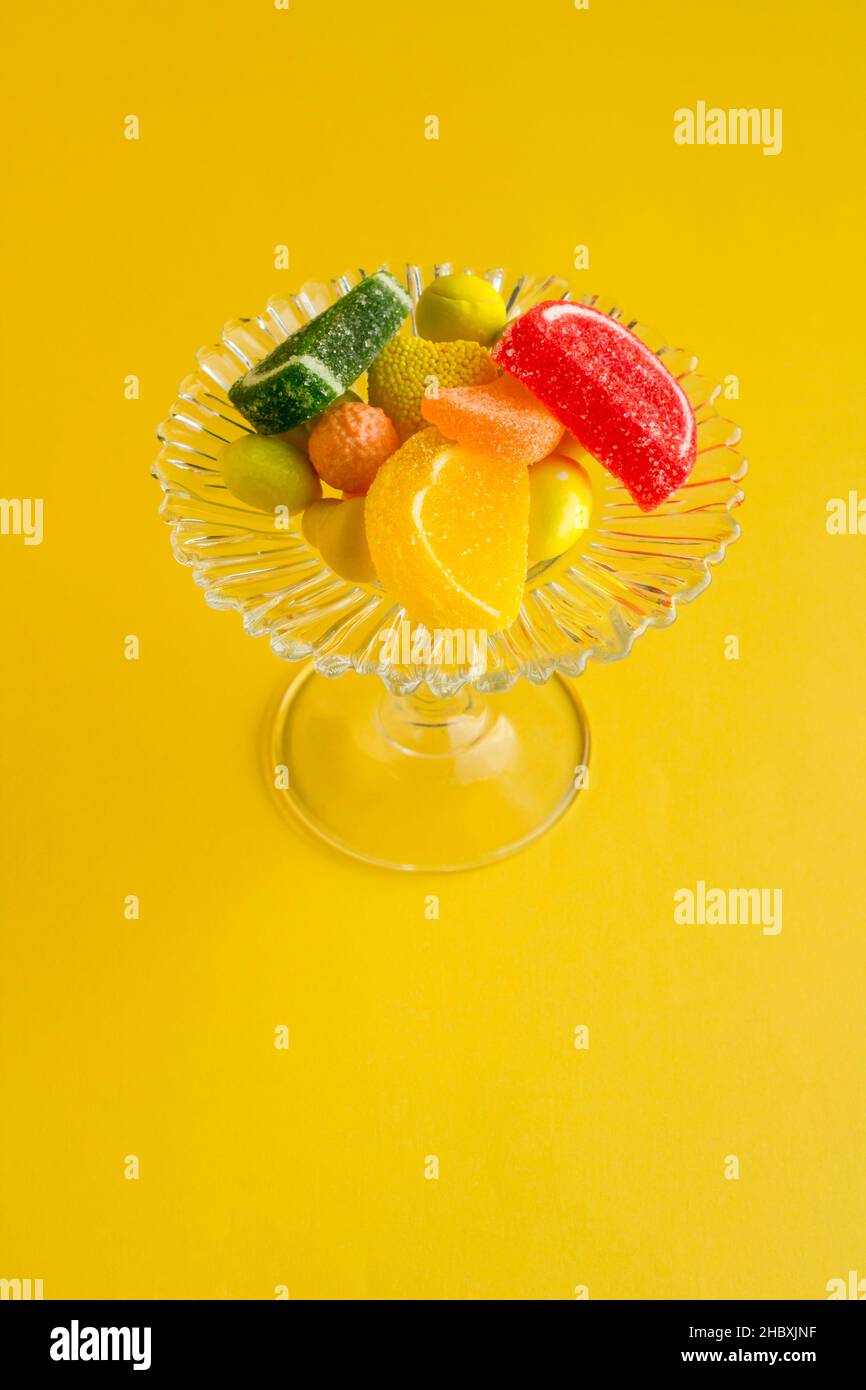 Colorful candies and chocolates designed on yellow background with