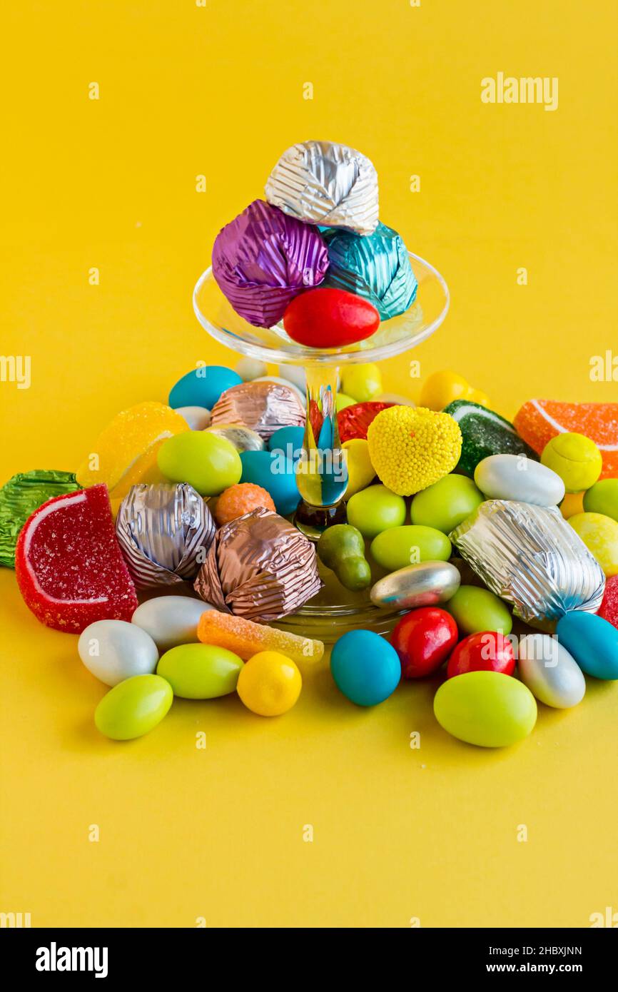 Colorful candies and chocolates designed on yellow background with