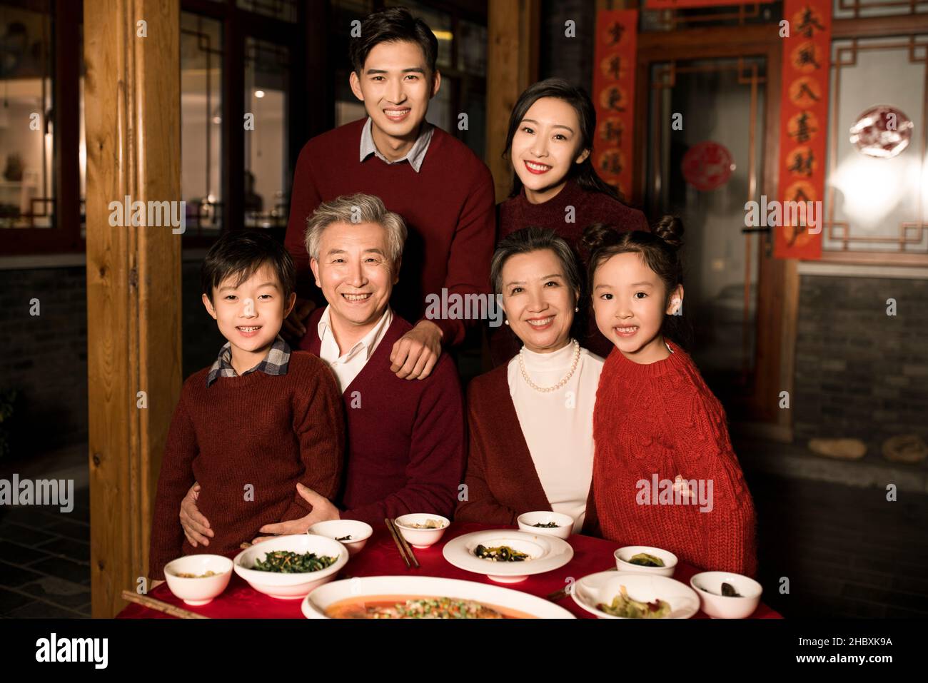 Happy families eating dinner on New Year's Eve Stock Photo