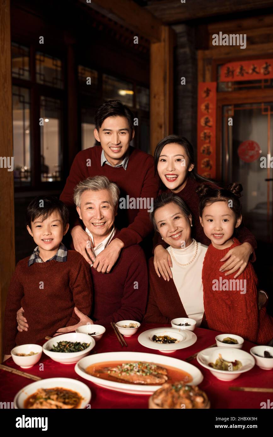 Happy families eating dinner on New Year's Eve Stock Photo