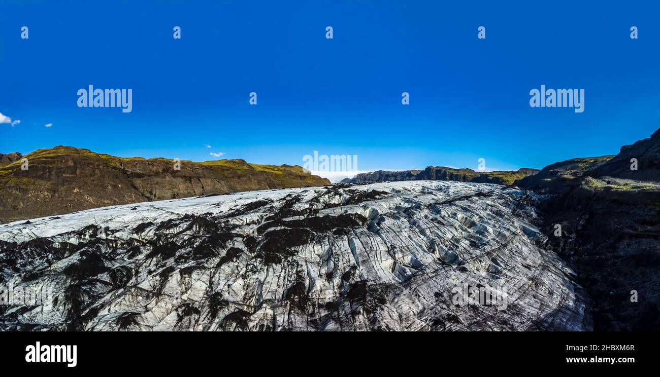 Massive glacier panorama under clear blue sky Stock Photo