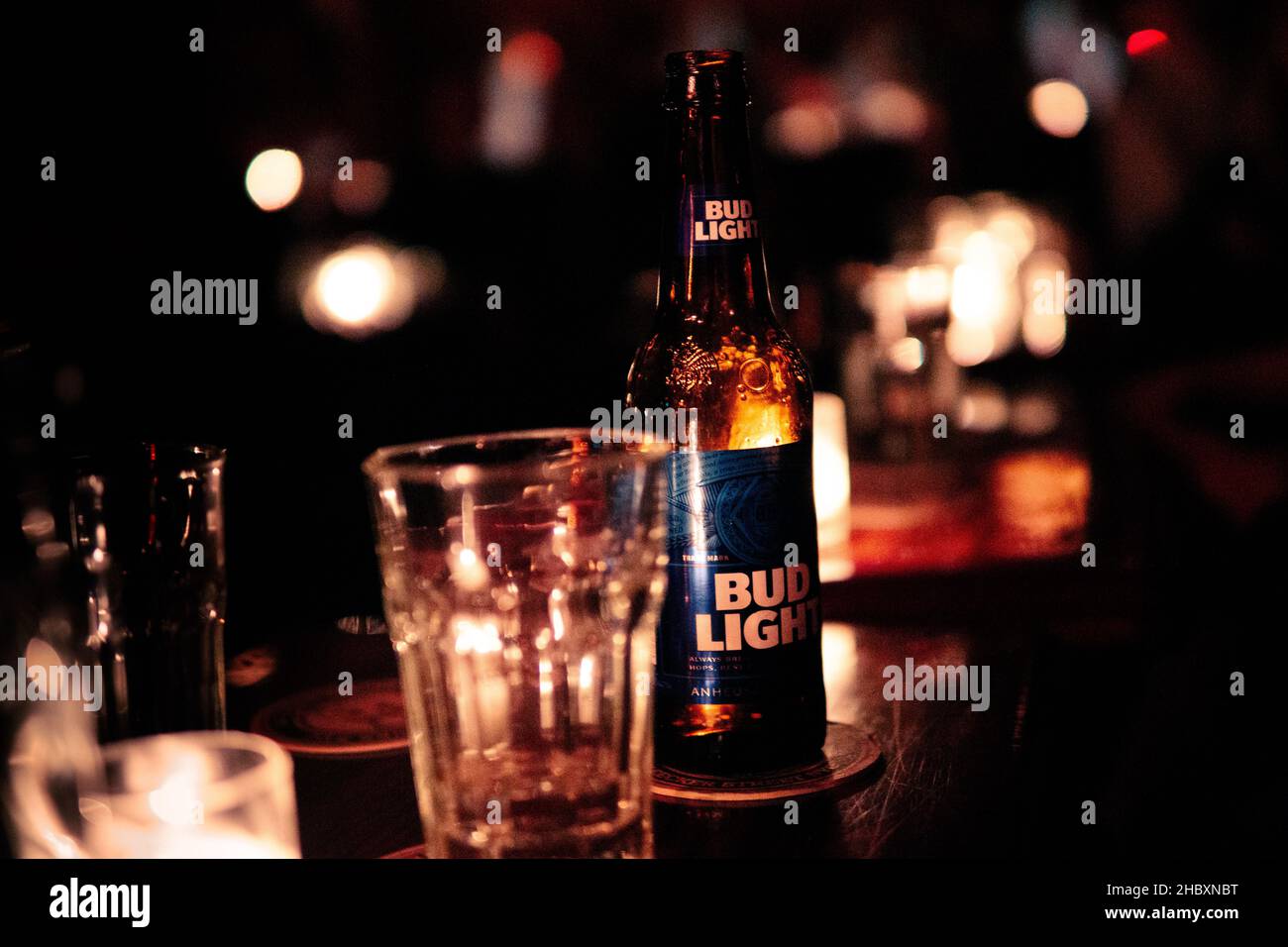 NEW YORK, UNITED STATES - Dec 06, 2019: A Bud Light beer and an empty glass at the counter in a New York bar Stock Photo