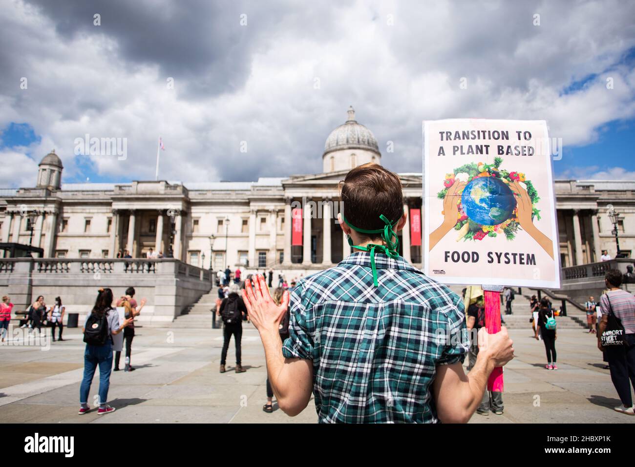 Animal Rebellion activists in Trafalgar Square holding placard Transition to a Plant Based Food System London 2020 Stock Photo
