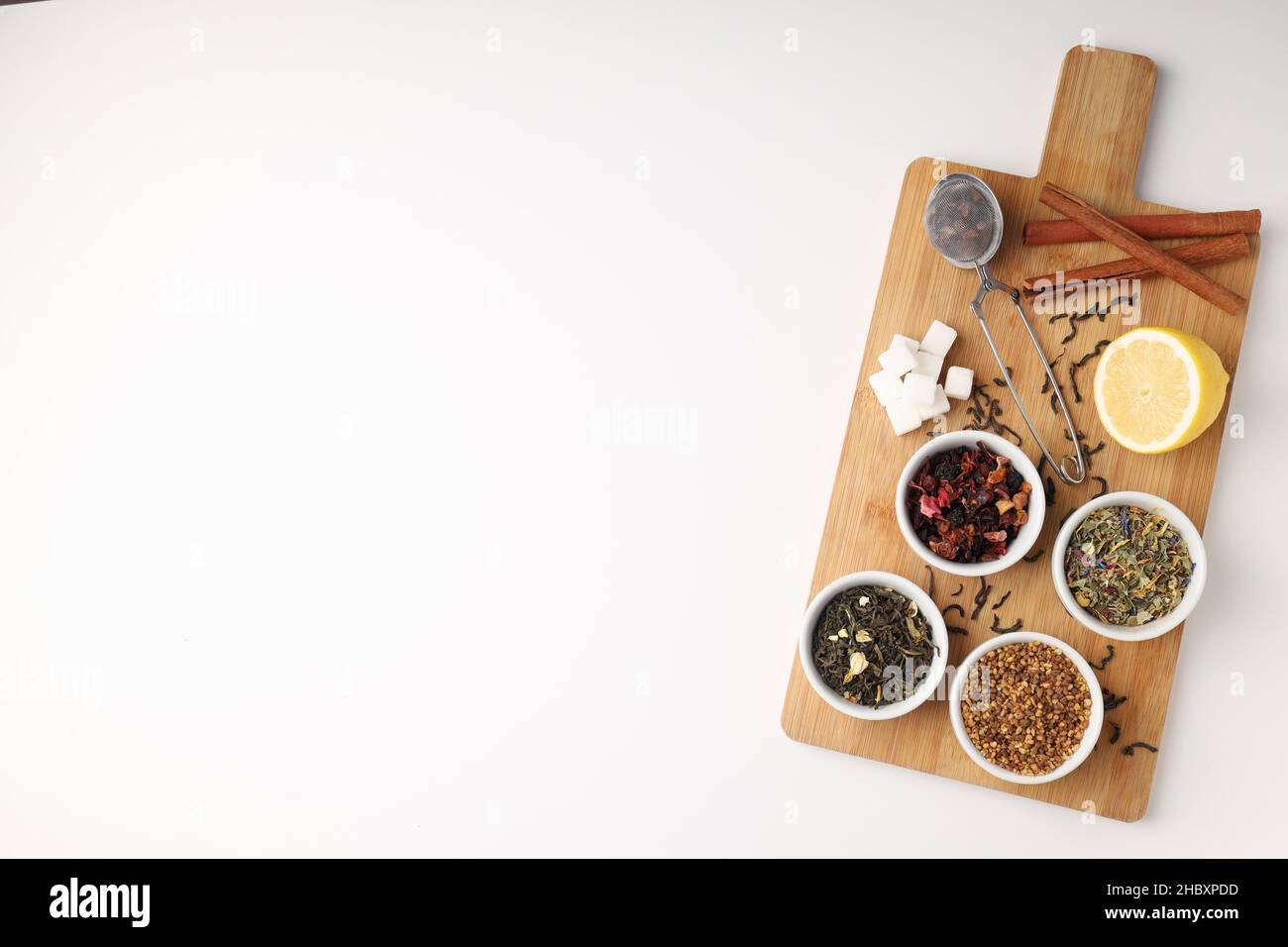 Concept of cooking tea with different types of tea on white background ...