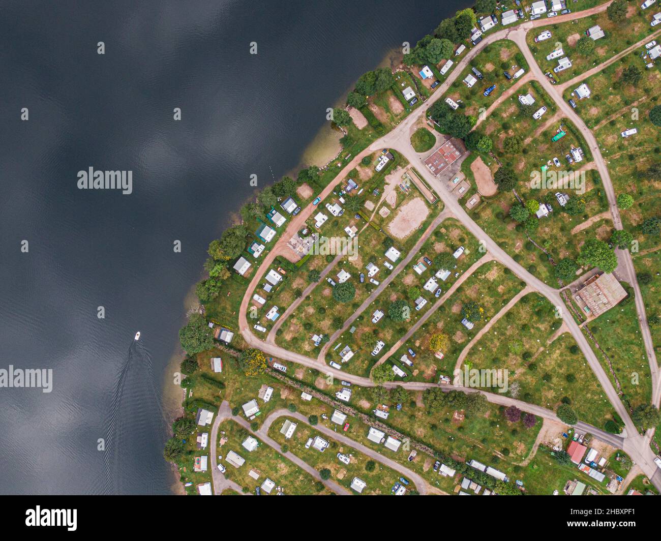 Aerial view of Longemer lake camping resort next to the lake water ...
