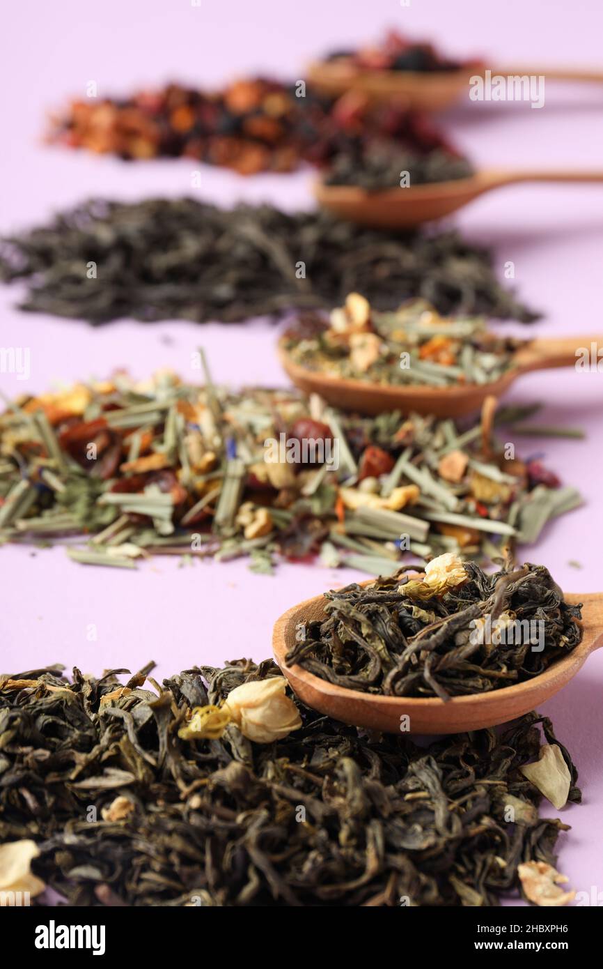 Concept of cooking tea with different types of tea on purple background ...