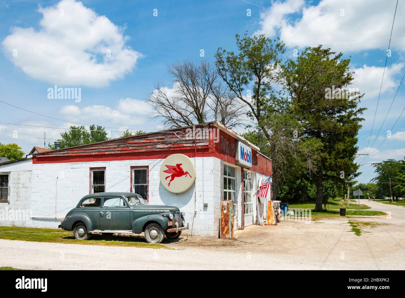 rusty old tokheim gas pump and classic American 1940 Chevrolet sedan at