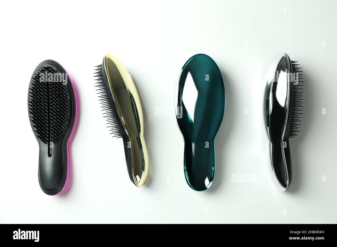 Colored plastic hair brushes on white background Stock Photo