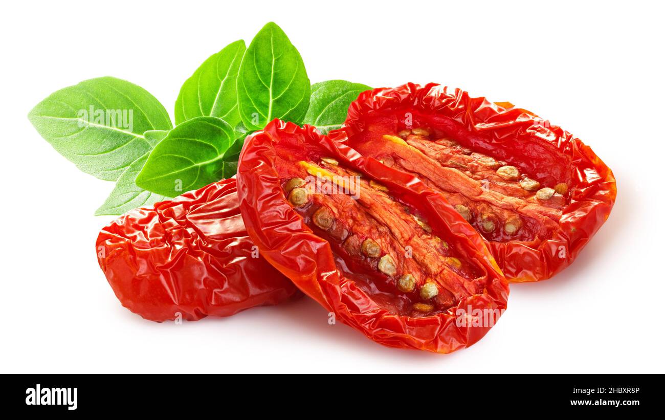 Dried or Sundried tomato halves with basil isolated Stock Photo