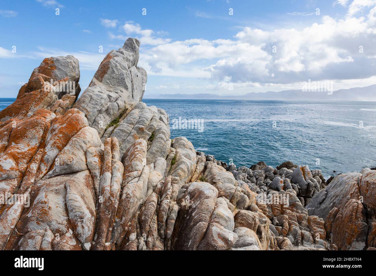 Jagged rocks on the Atlantic coast, waves on the water surface. Stock Photo