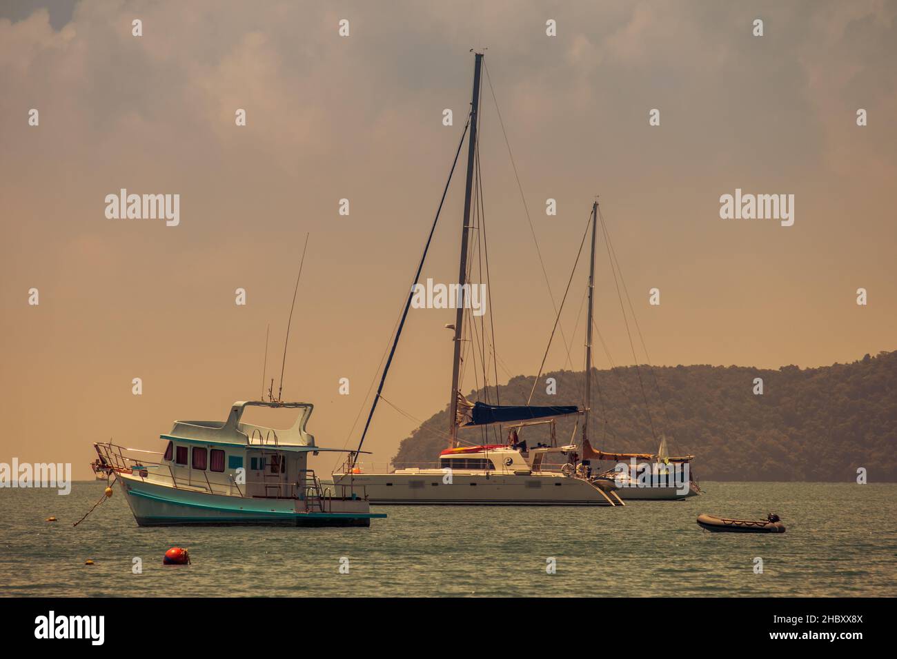 A beautiful shot of a bunch of boats in a sea at Ao Yon Beach, Phuket Stock Photo