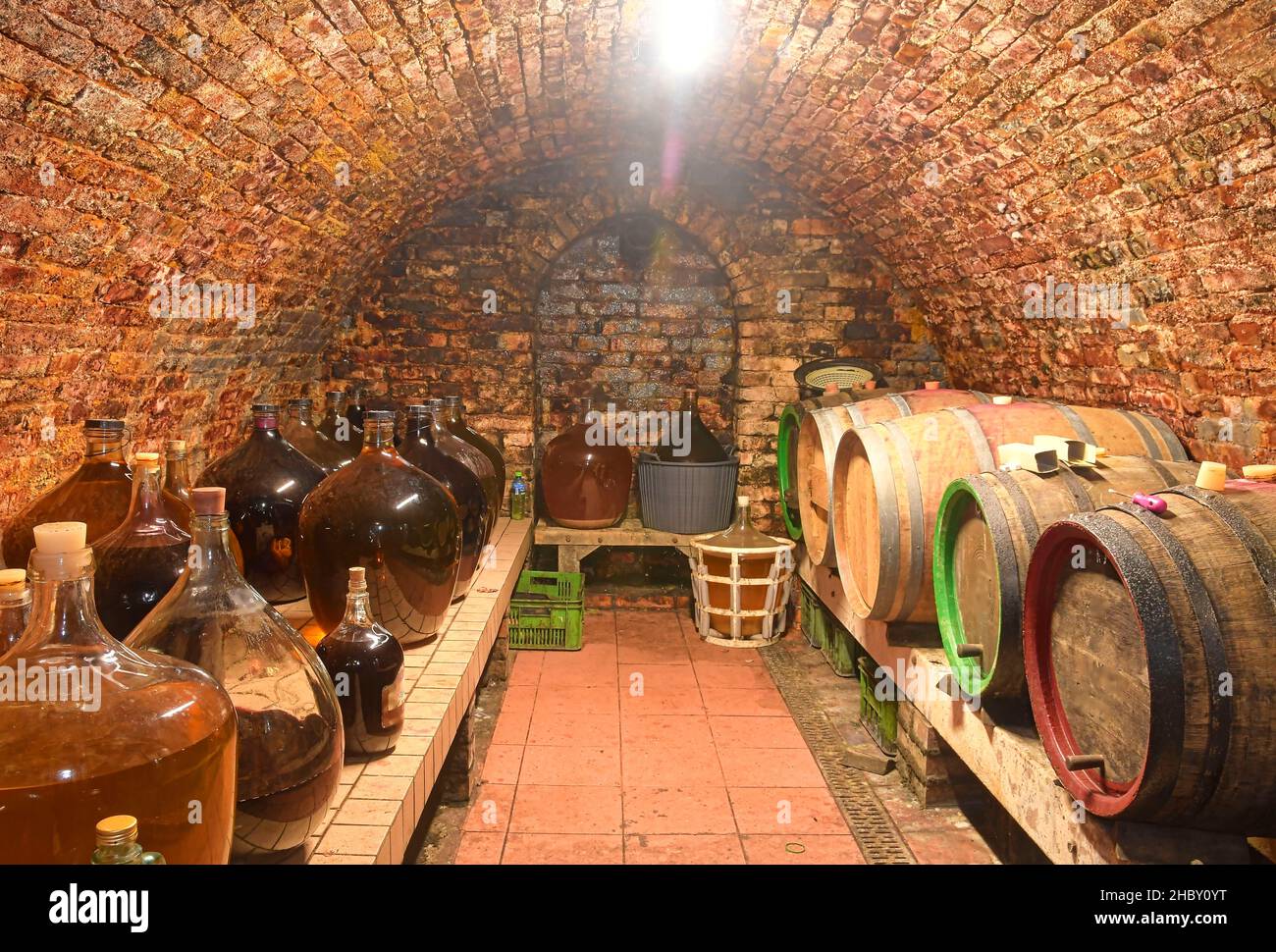Vintage demijohns in a traditional wine cellar. Demijohn wine bottles