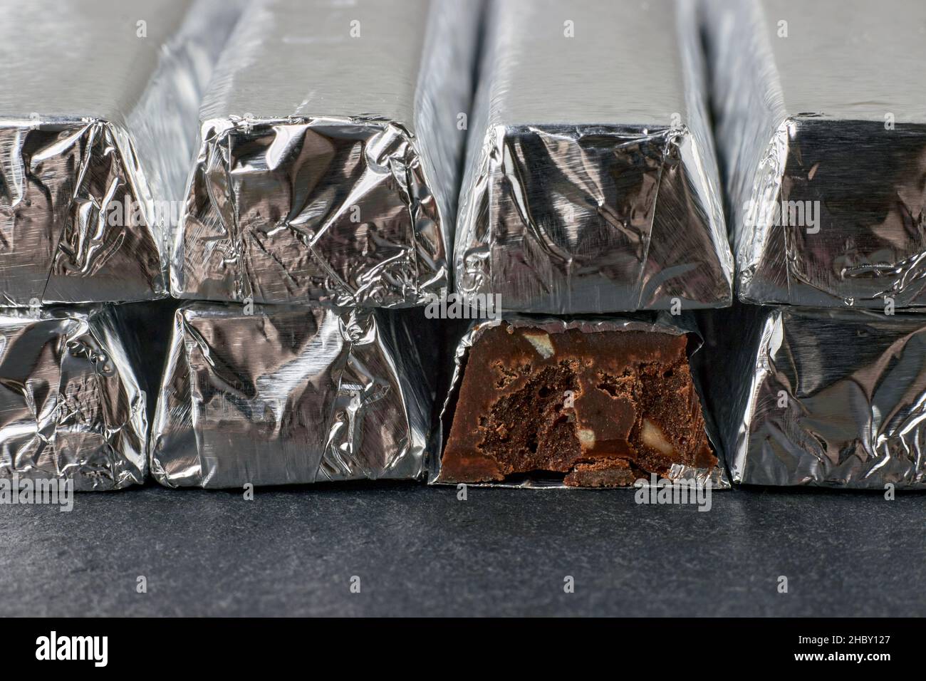 Dark chocolate bars with chopped nuts, wrapped in foil Stock Photo Alamy