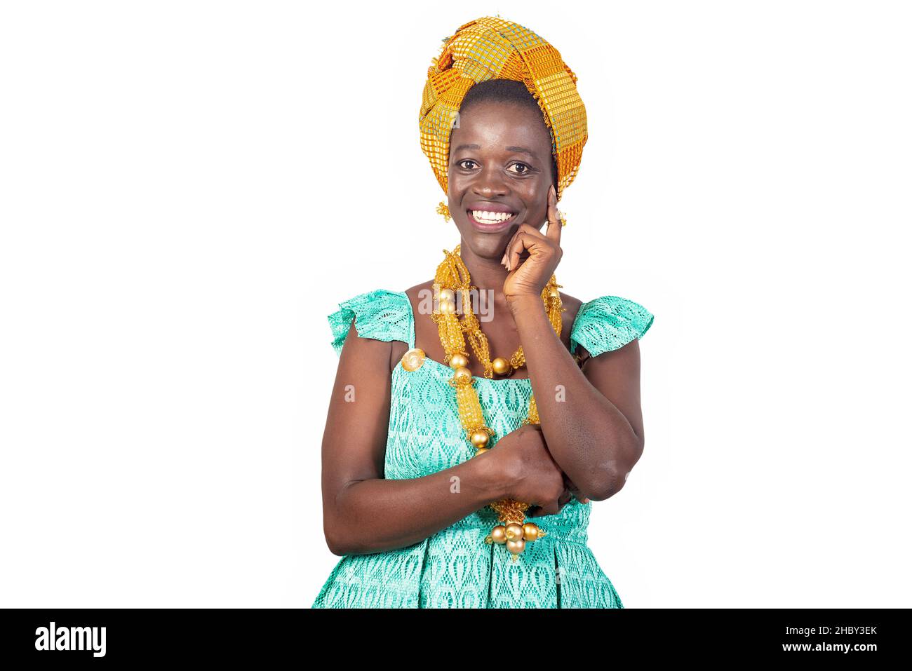 a beautiful young african woman in traditional dress standing on a ...