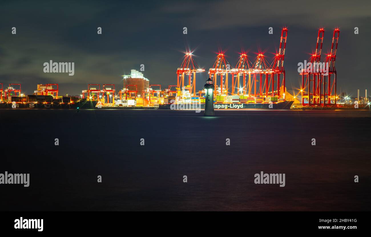 Seaforth Container Terminal on the River Mersey with New Brighton Lighthouse on the River Mersey in December 2021. Stock Photo