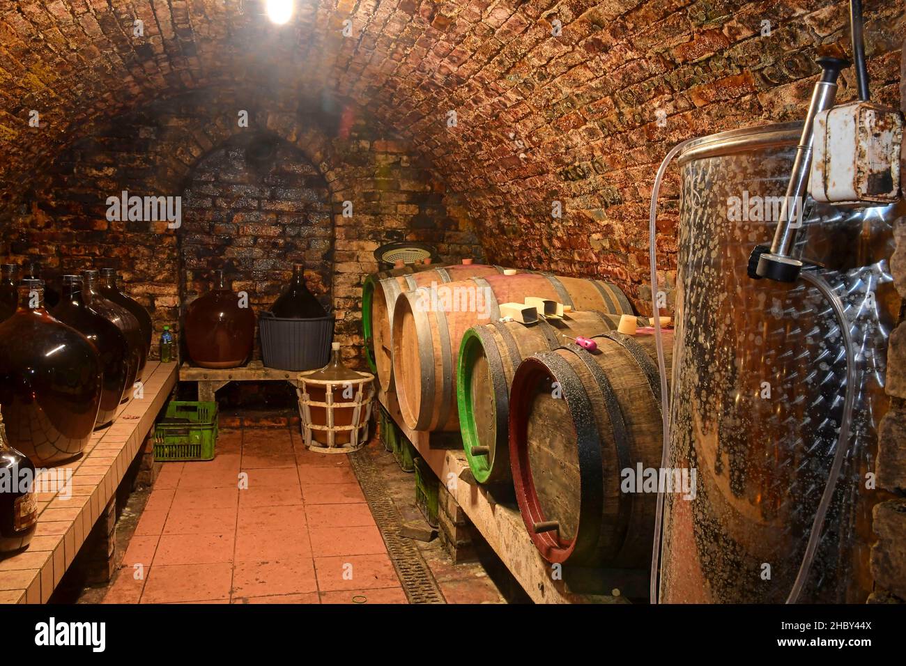 Vintage demijohns in a traditional wine cellar. Demijohn wine bottles