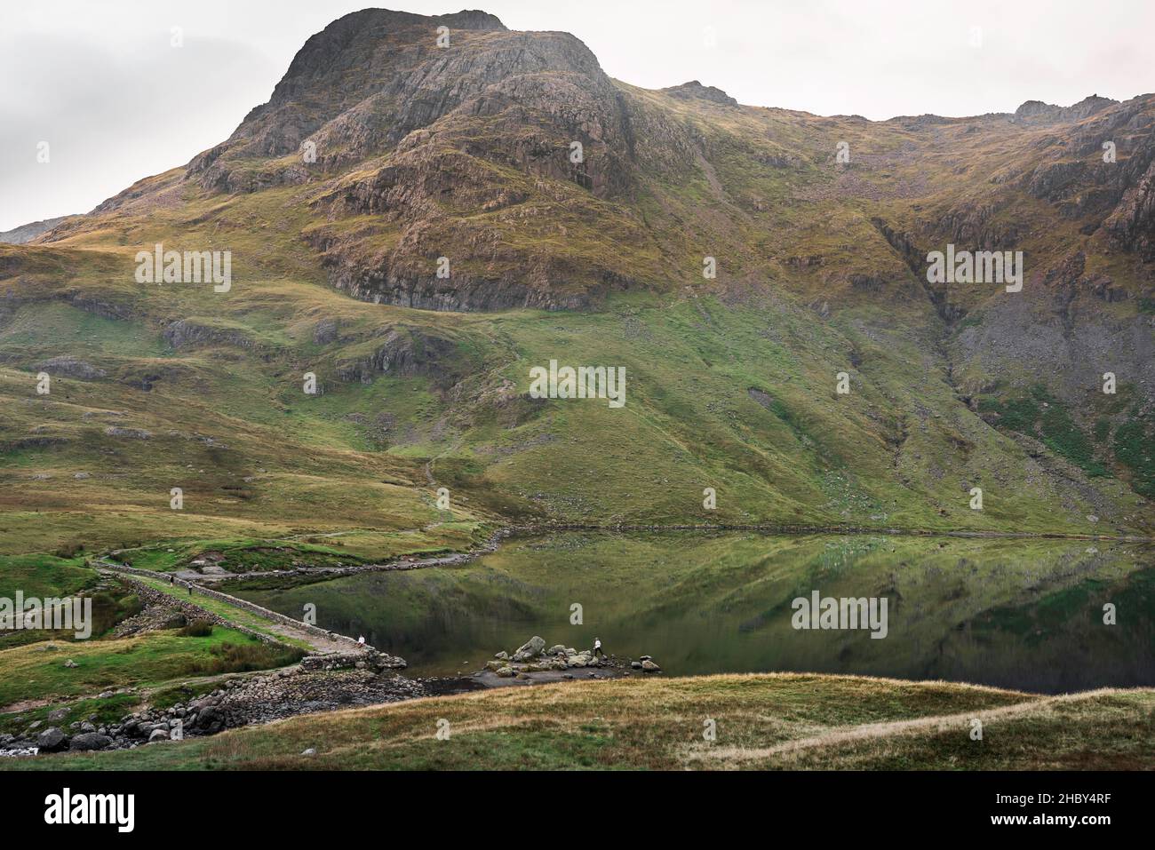 Stickle Tarn Cumbria, view of Stickle Tarn - a mountain lake set against the dramatic backdrop of the Langdale Pikes, Lake District, Cumbria, England Stock Photo