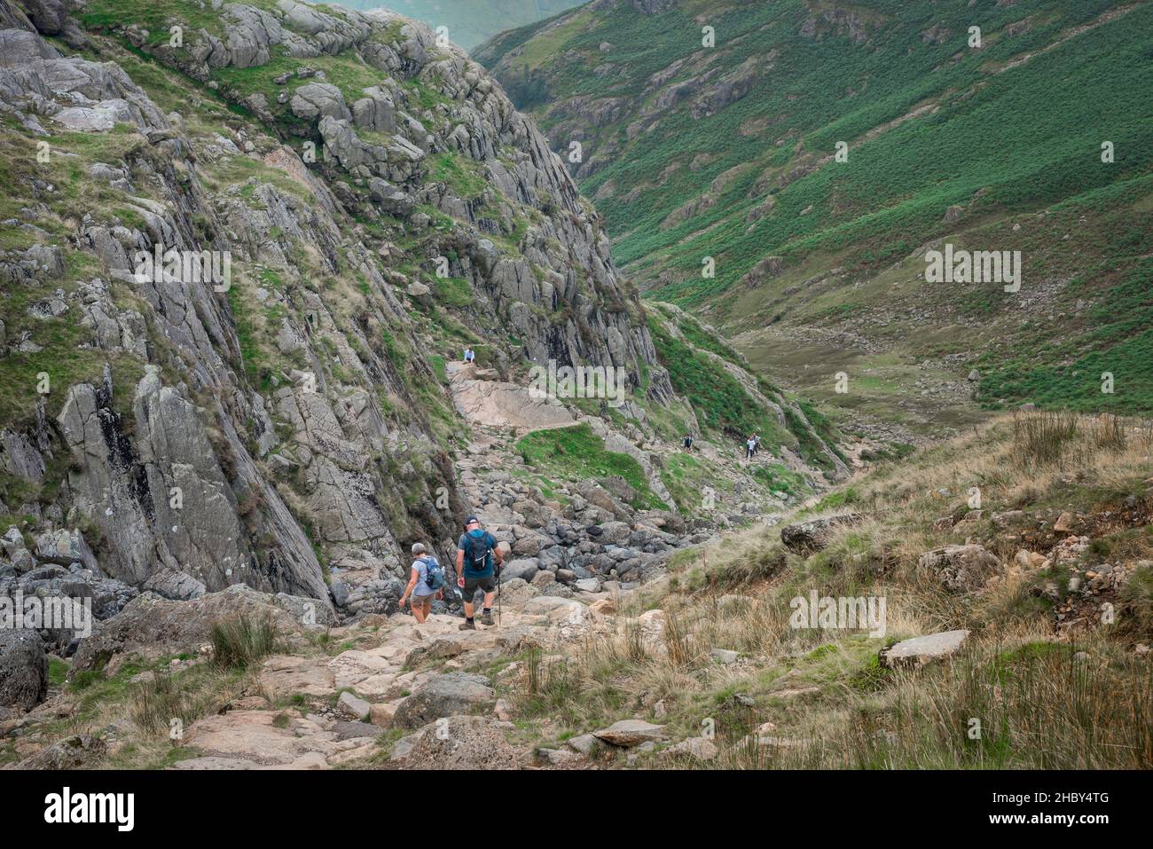 Langdale Cumbria, view of a mature couple descending Stickle Ghyll, a challenging trail leading up to the Langdale Pikes, Lake District, Cumbria, UK Stock Photo