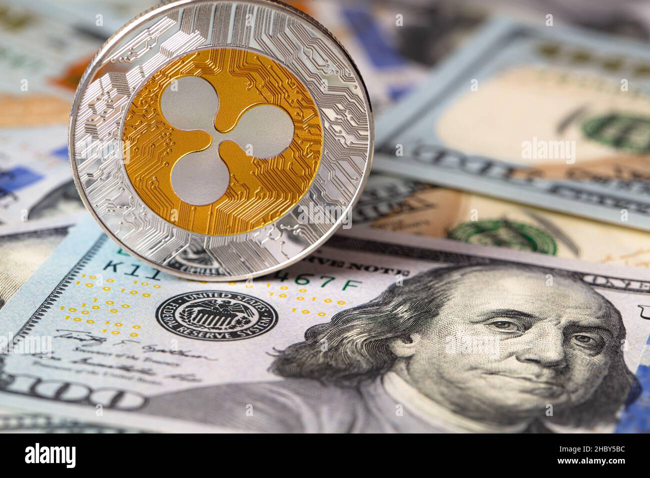 Ripple coin, XRP token, cryptocurrency on US 100 dollar background for  design purpose Stock Photo - Alamy