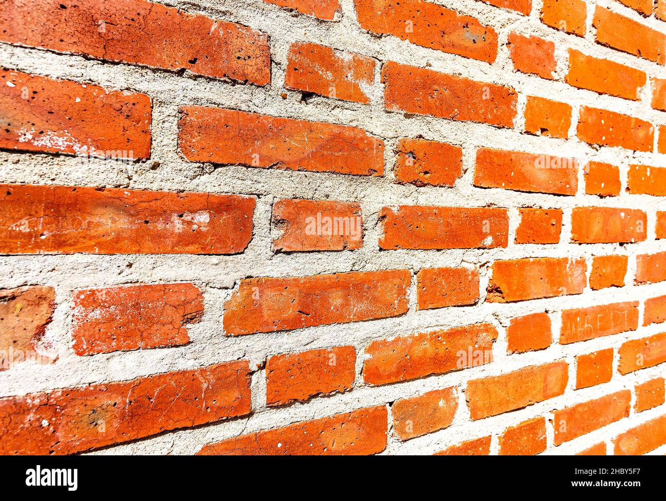 Weathered red brick wall as background. View from the angle Stock Photo